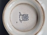a white bowl with a drawing of a fish on it