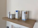 a shelf that has three boxes of creams on it