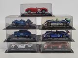six different model cars in a display case