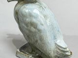 a statue of a bird that is sitting on top of a table