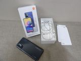 an image of a box with a phone and a charger on a table