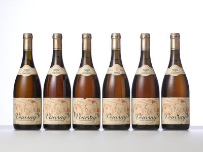 four bottles of wine are lined up on a table