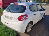 a small white car parked in a parking lot