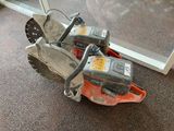 a chainsaw that is sitting on the floor next to a window