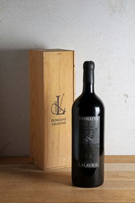 a bottle of wine sitting on a table next to a wooden box