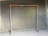 a metal frame with a orange top in the corner of a room