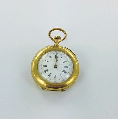 a gold pocket watch with roman numerals on the face