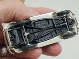 a person holding a toy car in their hand