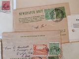 several old envelopes with stamps are on a white surface