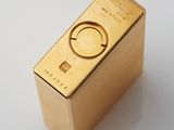 a gold lighter sitting on top of a white table