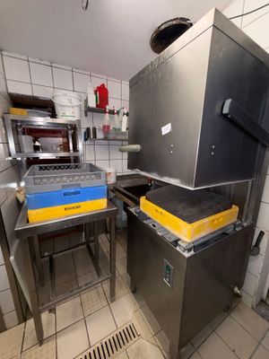 a kitchen with a stove, sink, and oven in it