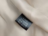 a close up of a white shirt with a black label on it
