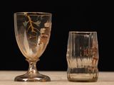 two glasses sitting next to each other on a table