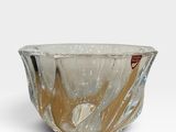 une image représentant un bol en verre posé sur une surface blanche