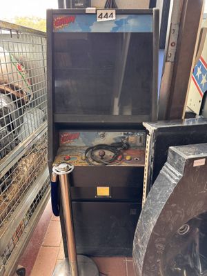 a machine that is sitting on the ground next to a trash can