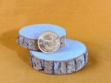a small piece of wood with a coin on top of it