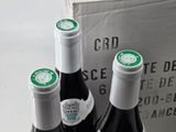 three bottles of wine that are sitting in a box