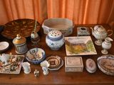 a wooden table with a lot of china and other items on it