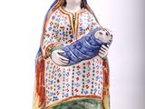 figurine of a woman holding a baby in her arms