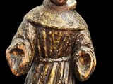 statue of a man in a brown robe holding a glass of wine