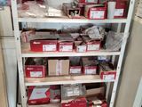 many boxes and packages on the shelves in the room