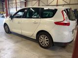 a small white car parked inside of a building