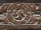a close up of a wooden carving on a wall