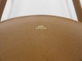 a close up of a brown purse with a white background
