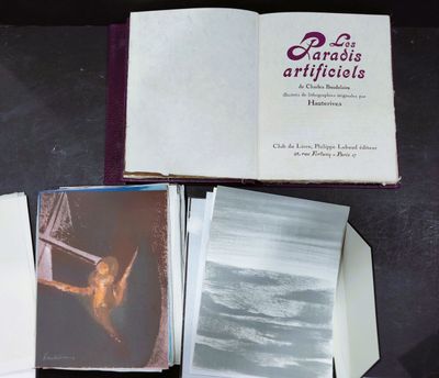 several books are open on a table with a picture of a woman in a boat