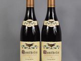two bottles of wine sitting next to each other on a table