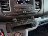 a dashboard of a car with a cup of coffee in it