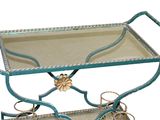 a metal cart with a glass shelf on it