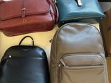 several different colored handbags are on display in a store