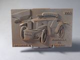 a belt buckle with a picture of an old car on it