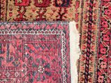 a close up of a rug with a red and black design