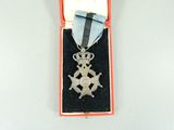 a silver medal with a star on it in a case