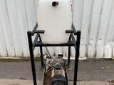 a white tank sitting on top of a metal stand