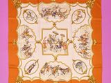 an orange and white square scarf with a picture of men on horseback