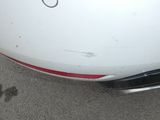 a close up of a car ' s bumper with a sticker on it