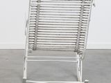 an image of a white rocking chair in a room with a white wall