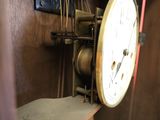 a clock that is on a shelf in a room