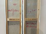 a wooden easel with a painting on it with writing on it