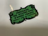 a green sign on a white plate that says poceline des ateliers parte d ' annet france