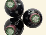 three bottles of wine sitting on top of each other