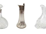 three glass vases and a silver vase on a white background
