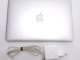 a white apple laptop with a charger and a charger