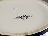 a blue and white plate with a name on it