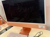 a computer monitor sitting on a desk with a keyboard and mouse
