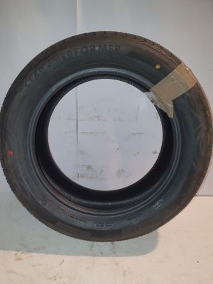 tire on a wall with a piece of paper taped to it