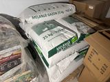 many bags of food sitting on top of a pile of boxes